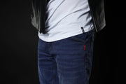 4SR GTS Blue motorcycle jeans front detail under leather jacket, showing clean seam and red 4SR tag