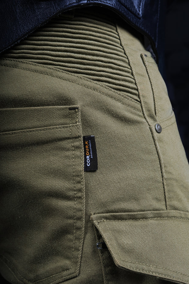 Close-up of 4SR Tourismo Green motorcycle jeans with Cordura® Denim label and reinforced stretch panels