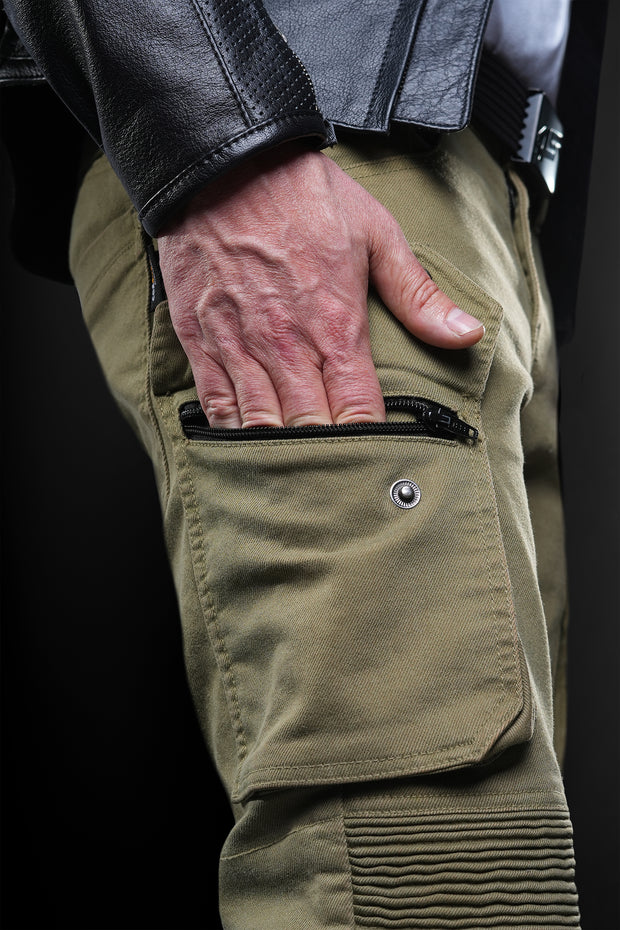 Close-up of 4SR Tourismo Green motorcycle jeans – rider using secure cargo pocket with hidden zipper and snap button closure