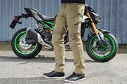 Side view of rider with 4SR Tourismo Green motorcycle jeans and textile RTX jacket, next to motorcycle