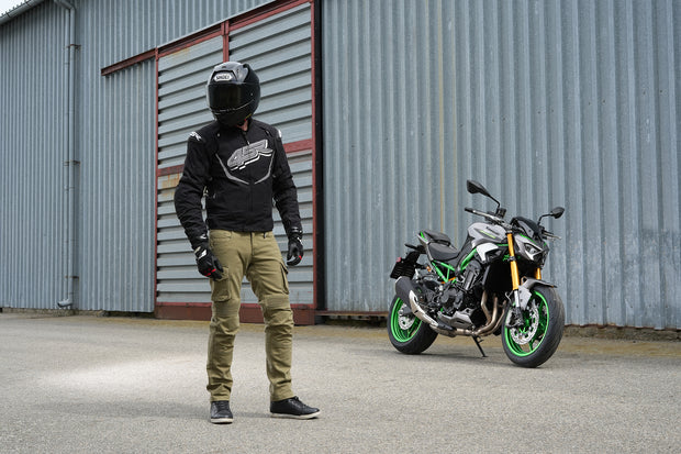 Rider wearing 4SR Tourismo Green motorcycle jeans with black textile RTX jacket – casual motorcycle outfit in Australia