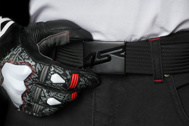 4SR Tourismo Black motorcycle jeans with 4SR belt buckle and racing gloves close-up