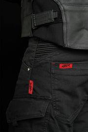 Close-up of 4SR Tourismo Black motorcycle jeans waistband and stretch panel, highlighting ergonomic fit and red logo tag.