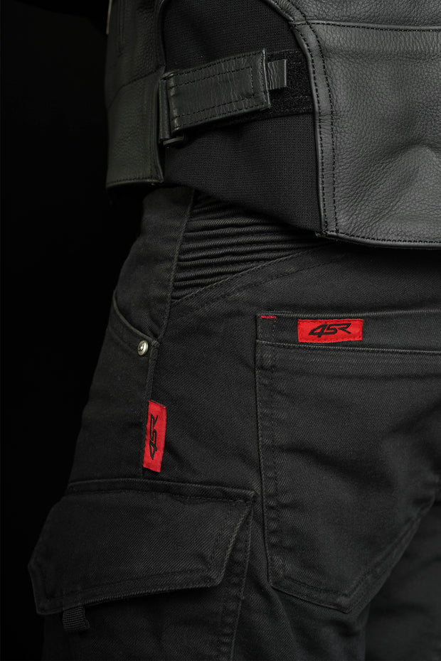 Close-up of 4SR Tourismo Black motorcycle jeans waistband and stretch panel, highlighting ergonomic fit and red logo tag.
