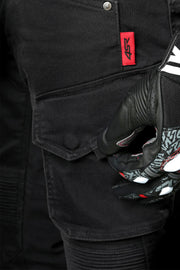 Detail of 4SR Tourismo Black motorcycle jeans cargo pocket with red 4SR label, shown with rider wearing protective glove.