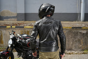 Motorcyclist in 4SR Scrambler Petroleum II leather jacket showing ergonomic longer back and quilted shoulder detail.