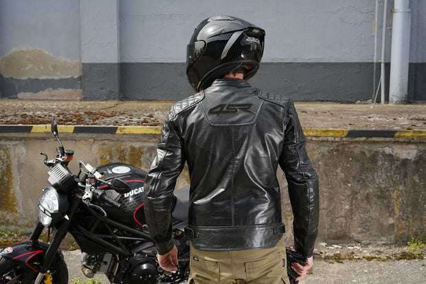 Motorcyclist in 4SR Scrambler Petroleum II leather jacket showing ergonomic longer back and quilted shoulder detail.